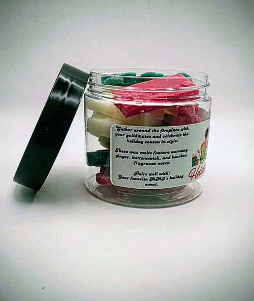 A jar of "Holiday Hearth" premium wax melts. The wax melts come in a clear plastic jar with a black lid, featuring a light-green label. The wax melts themselves come in an assortment of video game controller shapes and a mix of red, green, and white colors.