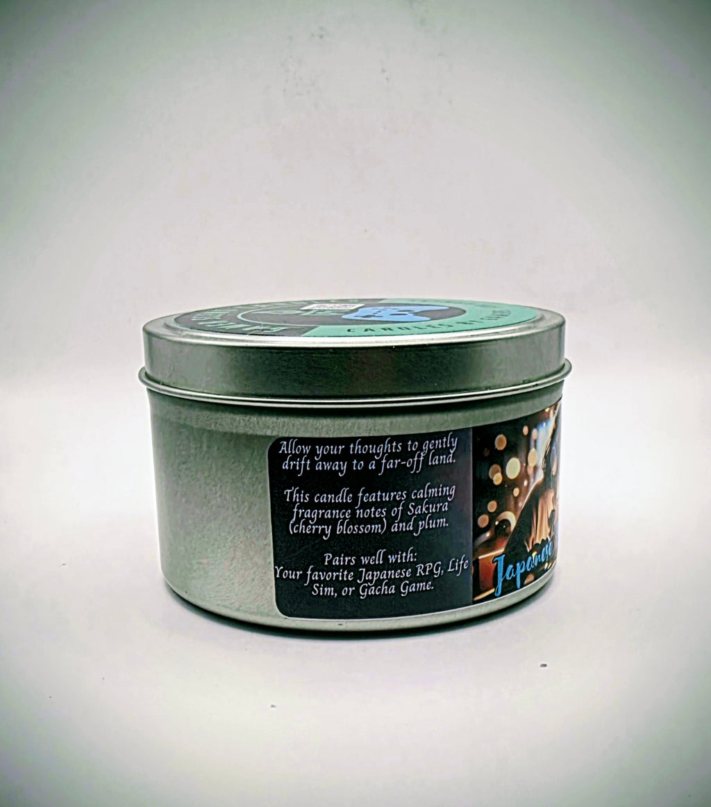 Our "Japanese Daydreams" candle in a 6 oz. tin. The candle features Sakura (cherry blossom) and plum fragrance notes. The candle is purple and features a purple label with a young Japanese girl wearing headphones, daydreaming during class. Our 6 oz. candles have approximately a 25 hour burn time.