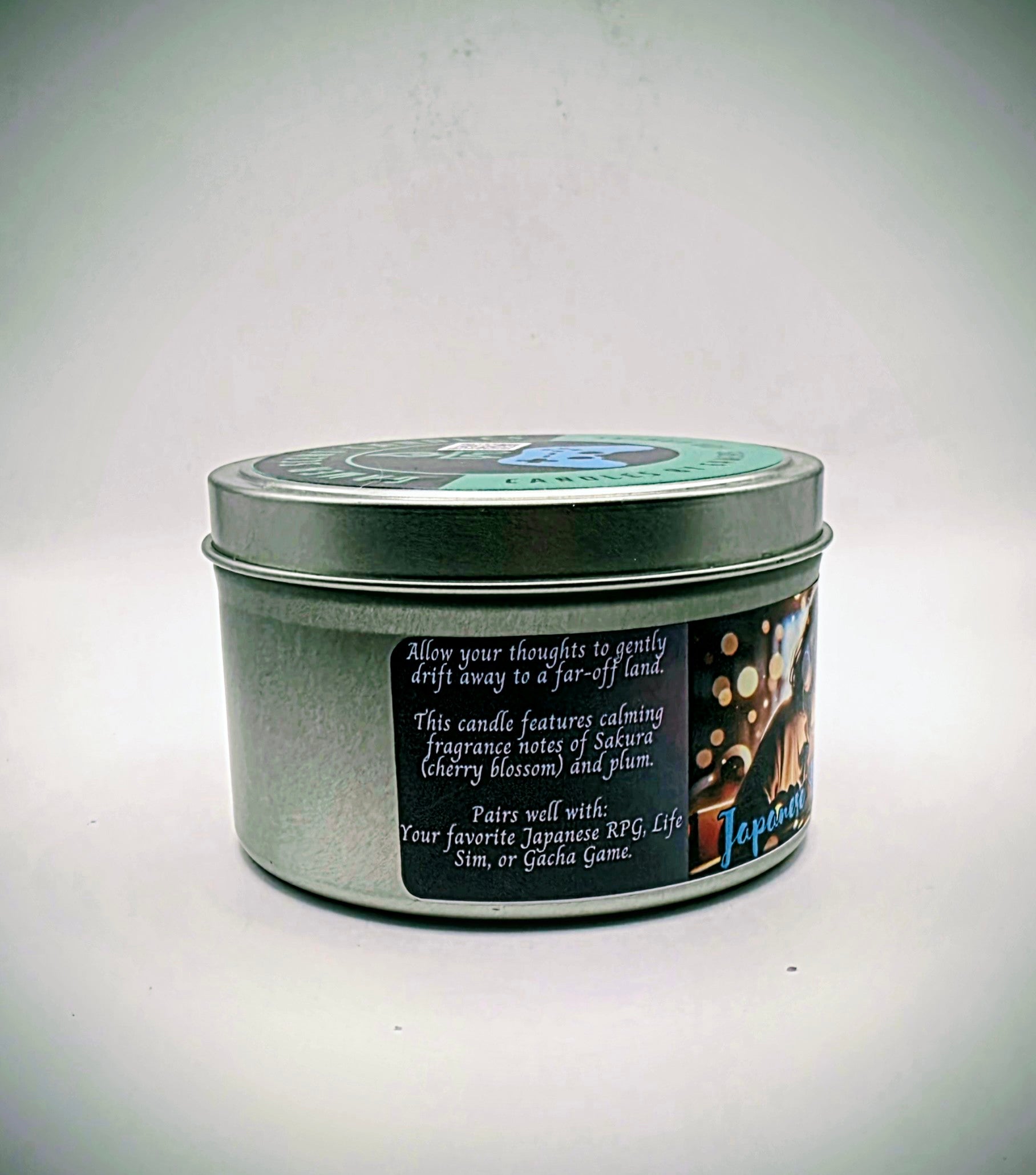 Our "Japanese Daydreams" candle in a 6 oz. tin. The candle features Sakura (cherry blossom) and plum fragrance notes. The candle is purple and features a purple label with a young Japanese girl wearing headphones, daydreaming during class. Our 6 oz. candles have approximately a 25 hour burn time.