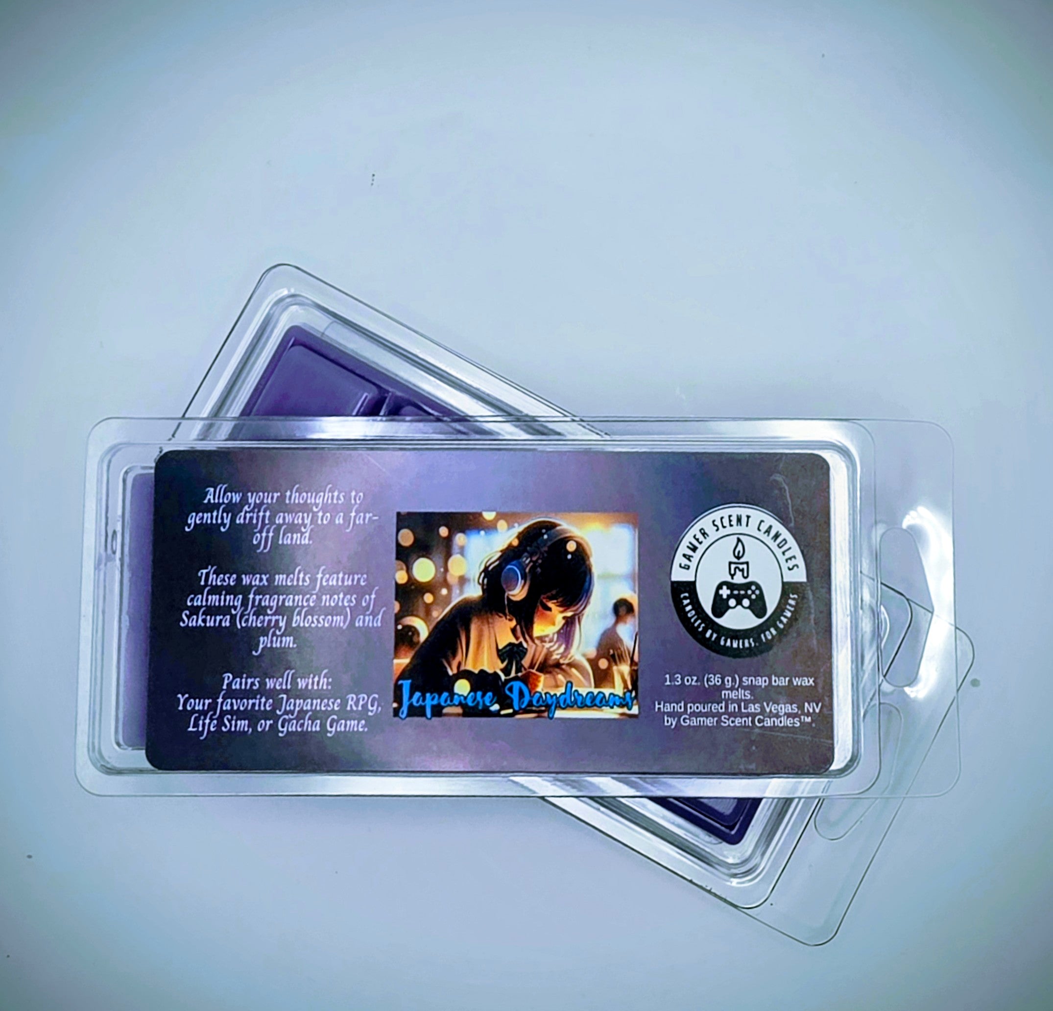 our Japanese Daydream snap bar wax melts feature calming fragrance notes of Sakura (cherry blossom) and plum. The purple label features a young Japanese girl, wearing headphones, while she daydreams in class.