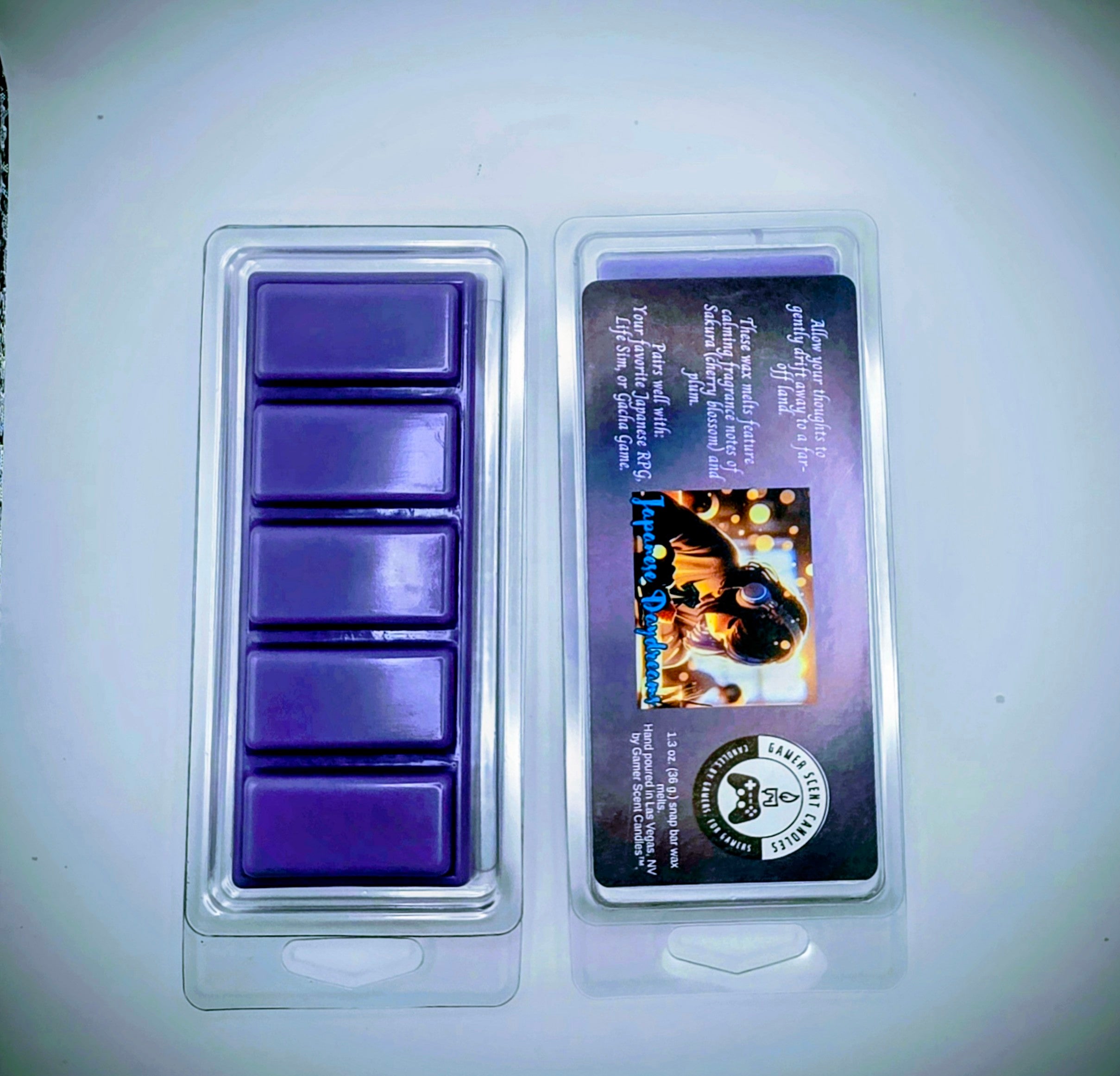 our Japanese Daydream snap bar wax melts feature calming fragrance notes of Sakura (cherry blossom) and plum. The purple label features a young Japanese girl, wearing headphones, while she daydreams in class.