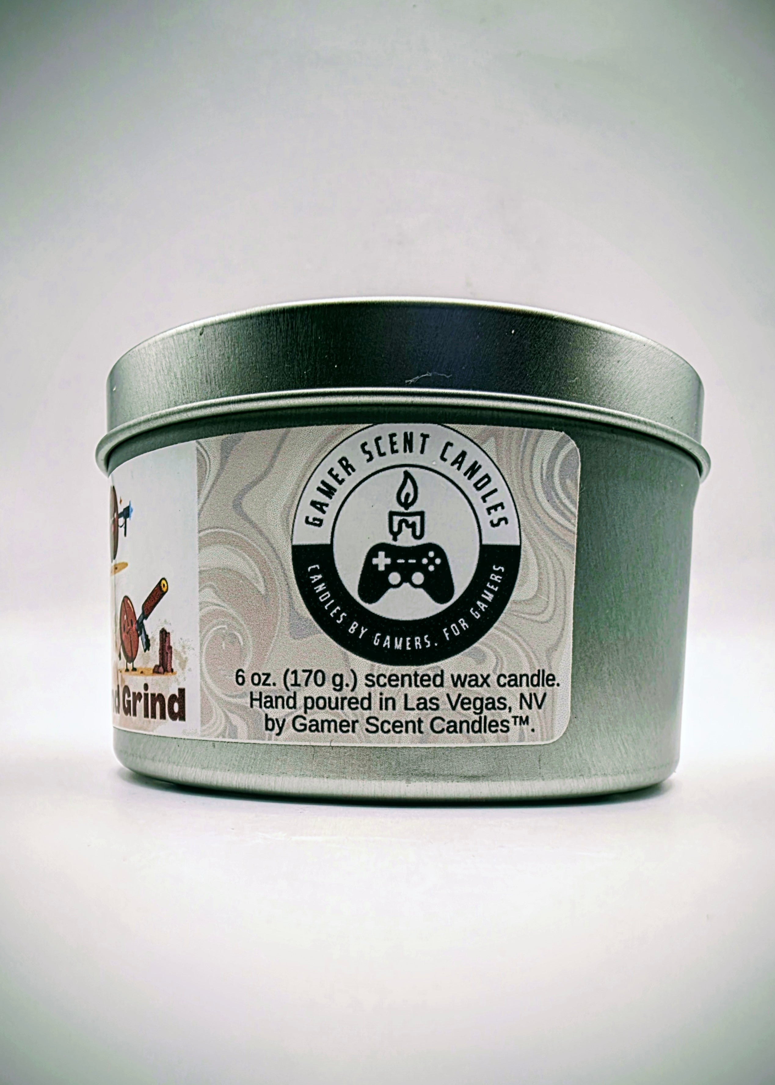 Our "Rise and Grind" fragrance in a 6 oz. tin. It features bold fragrance notes of fresh brewed coffee infused with salted honey butter. Our 6 oz. tins have approximately a 25 hour burn time. The label features cartoon coffee beans with weapons.