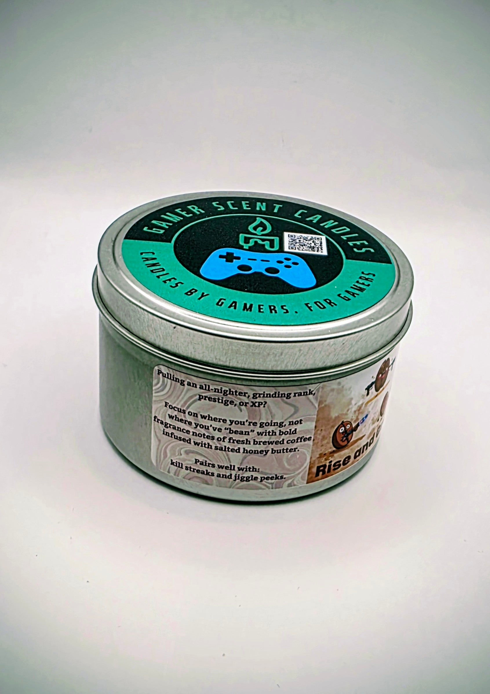 Our "Rise and Grind" fragrance in a 6 oz. tin. It features bold fragrance notes of fresh brewed coffee infused with salted honey butter. Our 6 oz. tins have approximately a 25 hour burn time. The label features cartoon coffee beans with weapons.