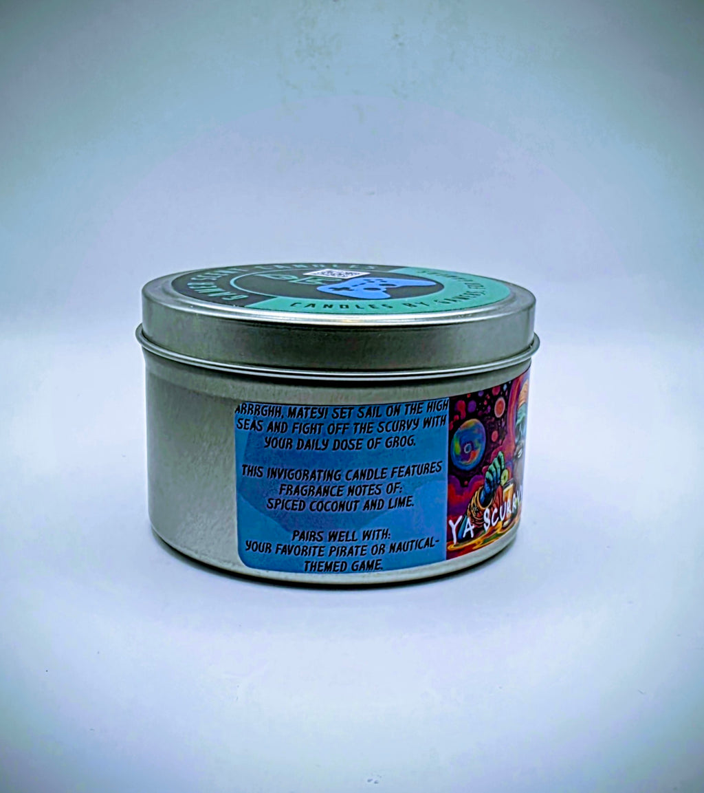 Our "Scurvy Dog" candle in a 6 oz. tin. The candle features spiced coconut and lime fragrance notes. The candle is blue and features a blue label with a psychedelic pirate holding a drink garnished with a lime. Our 6 oz. candles have approximately a 25 hour burn time.