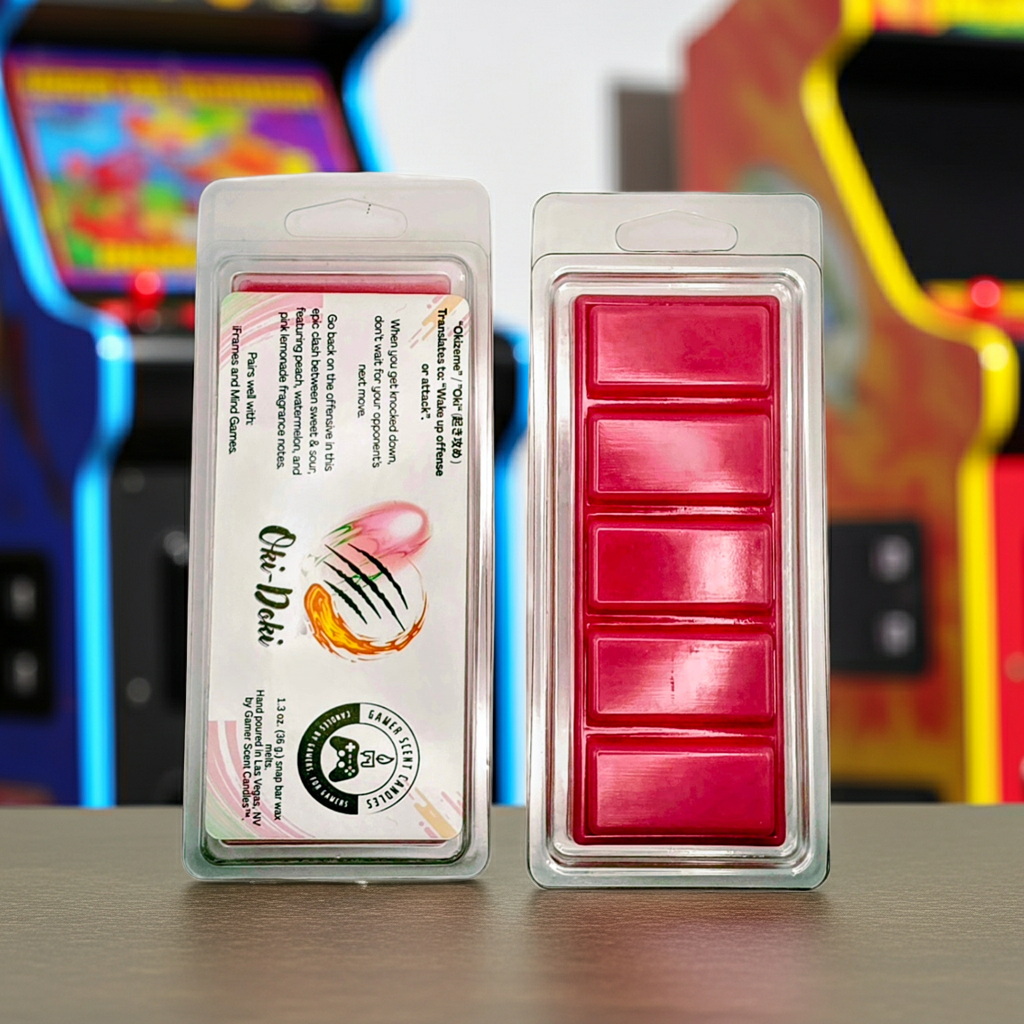 Oki-Doki snap bar wax melts. On a table in front of several arcade cabinets. Front and back. Side-by-side.  Video game wax melts. Perfect gift for gamers. Premium soy wax scented wax melts. Wax tarts.